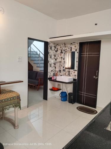 a living room with a sink and a bathroom at Wale's Hilltop Villa in Kolhapur