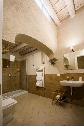 a large bathroom with a sink and a toilet at Secret B&B in Trapani