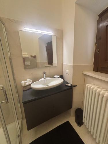 a bathroom with a sink and a mirror at La Dimora del Duomo in LʼAquila