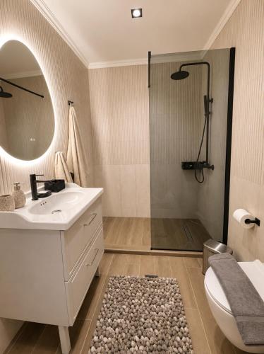 a bathroom with a toilet and a sink and a shower at Noema City View in Xanthi