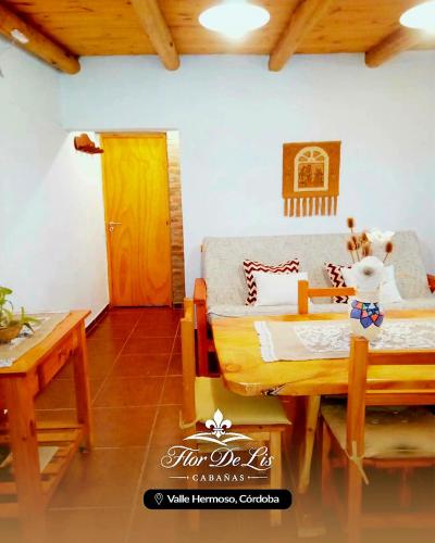 a bedroom with a bed and a table and a door at Cabañas Flor De Lis in Valle Hermoso