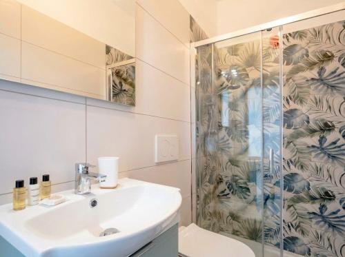 a bathroom with a sink and a shower at SanVitoStea Seafront Apartments in San Vito