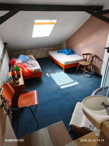 a room with two beds and a sink in it at Centrum Panzió VIP in Kaposvár