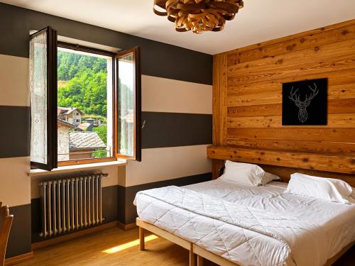 a bedroom with a bed and a window at Albergo Nazionale di Vernante in Vernante