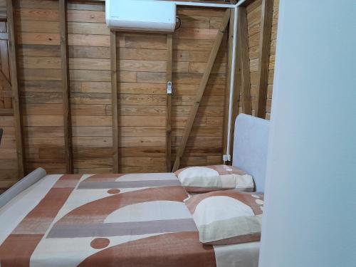 a bedroom with a bed and two chairs in it at Studio LAVANDES in Lamentin