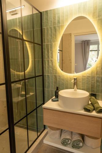 a bathroom with a sink and a mirror at Le Castelas - Suite Calisson in Aurons