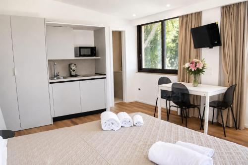a hotel room with a bed and a table with towels at Sarah apartment in Taormina
