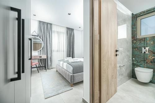 a bathroom with a bed and a toilet in a room at Luminoza Villa Zakynthos in Volímai