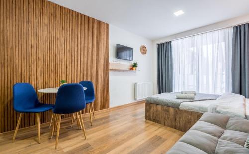 a bedroom with a bed and a table and chairs at New Gudauri LOFT in Gudauri