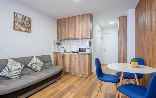 a living room with a couch and a table at New Gudauri LOFT in Gudauri