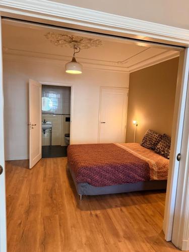 a bedroom with a bed in the middle of it at historic city apartment with private parking in Gouda