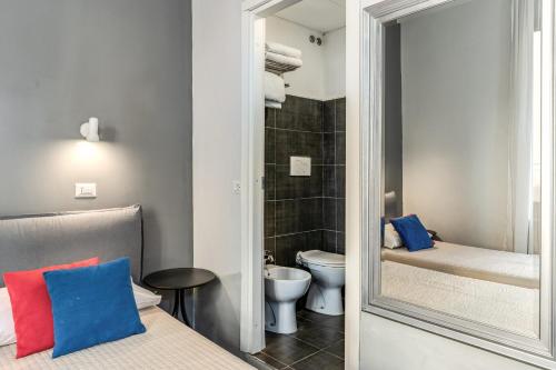 a small bathroom with a toilet and a mirror at Hotel Castelfidardo in Rome
