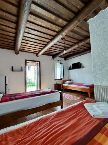 a large room with two beds and a window at Pensiunea San Pio Sabisa in Săbişa