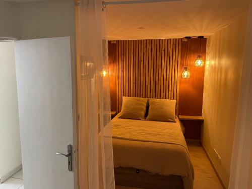 a bedroom with a bed in a small room at Le petit chalet in Luc-en-Diois