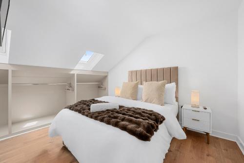 a bedroom with a large white bed with a brown blanket at Private Double Room in Spacious House with Garden in Blackrod
