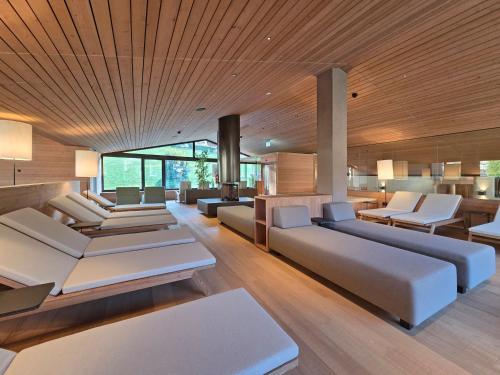a living room with couches and tables and chairs at Appartements Pedescin in Ortisei