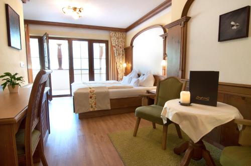 a hotel room with a bed and a table with a candle at Hotel Sieghard Zillertal in Mayrhofen