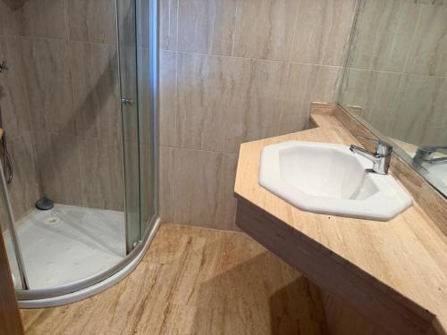 a bathroom with a sink and a shower at Blu capri in Dar Bouazza