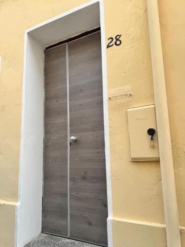 a door in the side of a building at Hour Home in Iglesias
