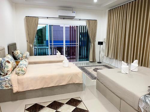 a hotel room with two beds and a window at singgah homestay yala2 in Ban Sarong