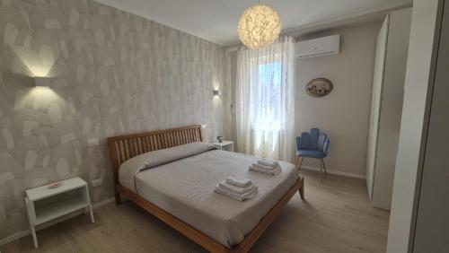 a bedroom with a bed and a blue chair at CasaLù in Lanciano