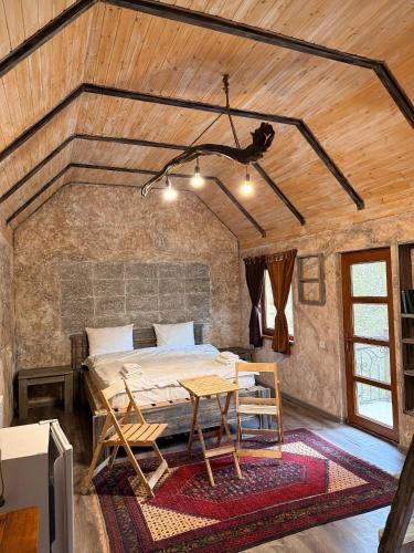 a bedroom with a bed and a table in a room at Dili Dzor in Dilijan