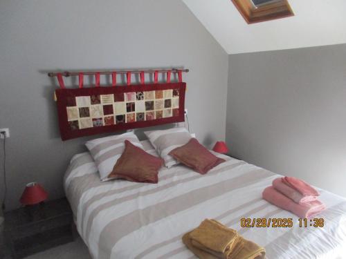 a bedroom with a bed with pillows on it at Soir en Sologne in Neuvy-sur-Barangeon