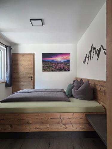 a bedroom with a wooden bed in a room at Mountainlights Apartment in Neustift im Stubaital