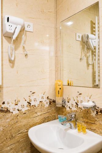 a bathroom with a sink and a mirror at Cottage Shina in Kazbegi