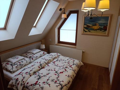a bedroom with two beds and two windows at Secret Residence with Sauna & Private Pool in Kościelisko