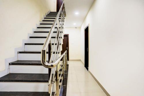 a staircase with a metal handrail in a building at SPOT ON Hotel Shree Ji in Indore