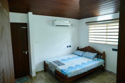 a bedroom with a bed with a wooden ceiling at CatsClaw Inn in Talayolaparambu