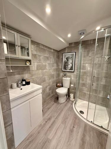 a bathroom with a toilet sink and a shower at The Willow Luxury Countryside Retreat in Stone