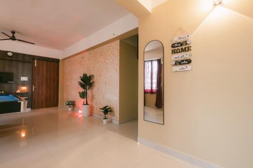 a living room with a sign on a wall at CueCasa in Guwahati