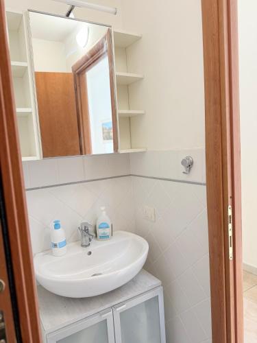 a bathroom with a sink and a mirror at Casina Toscana in Certaldo