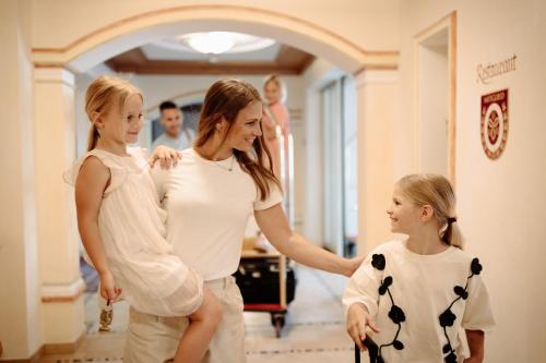 a woman and two little girls standing in a room at Berghof-Chalet in Erpfendorf
