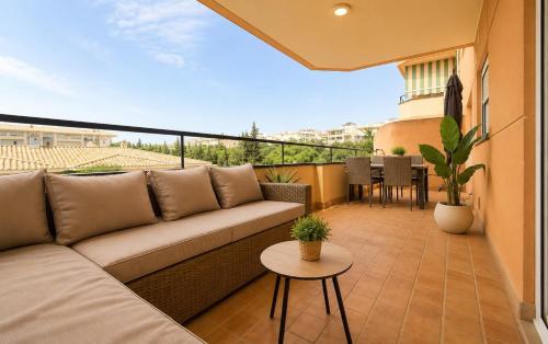 a living room with a couch and a table on a balcony at BlueSabinillas in San Luis de Sabinillas