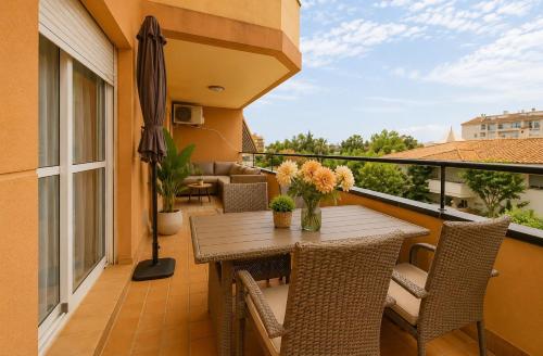 a balcony with a wooden table and chairs at BlueSabinillas in San Luis de Sabinillas