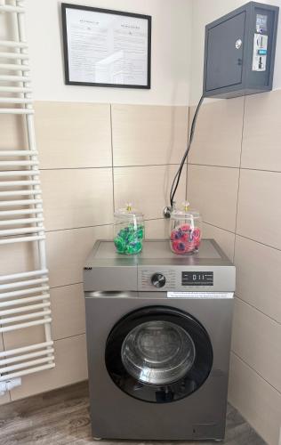 a washing machine with two candles on top of it at Ferienwohnung Kleinôd Sayn in Bendorf