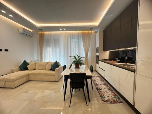 a kitchen and a living room with a table and a couch at Maison Miry in Rapallo