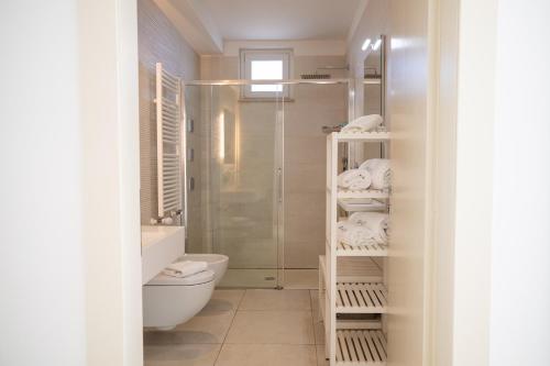 a bathroom with a shower and a toilet and a sink at Hotel Cicò in Torre Santa Sabina