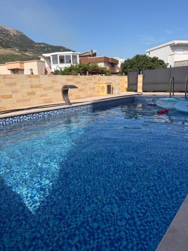 a large swimming pool with a bird in the water at Vila Sami in Bar
