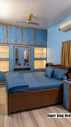a bedroom with a large bed with blue sheets at Shree niwas- Blue Room in Bokāro
