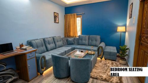 a blue living room with a couch and a table at Shree niwas- Blue Room in Bokāro