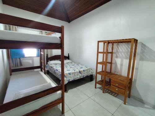 a room with two bunk beds and a small bedroom at Dunas House in Luis Correia