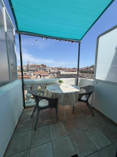 a table and chairs on a balcony with a view at Les Terrasses, charme et authenticité en Hyper Centre de TOULON, Idéal pour un séjour romantique ou une escapade urbaine in Toulon