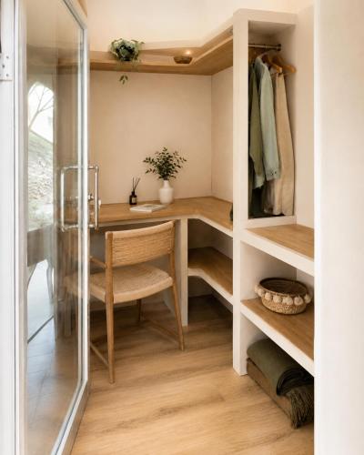 a small room with a desk and a closet at Sodade Eco Camp in Portela