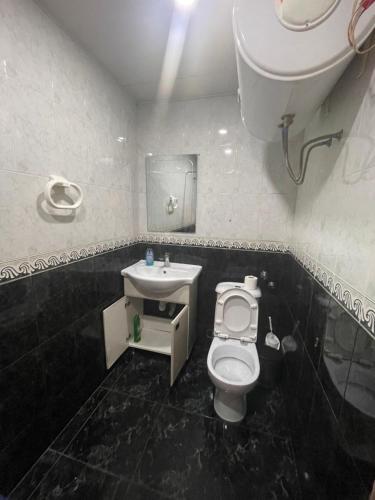 a bathroom with a toilet and a sink at Poti apartment in Poti