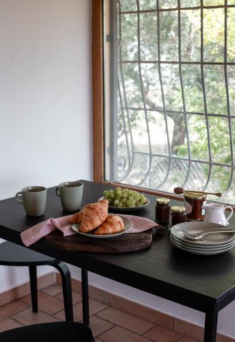 a table with a plate of croissants and grapes at The Lake Escape - Trevignano in Trevignano Romano