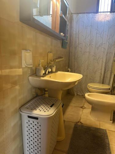 a bathroom with a sink and a toilet at Giardino di Chiara al mare in Torre Rinalda